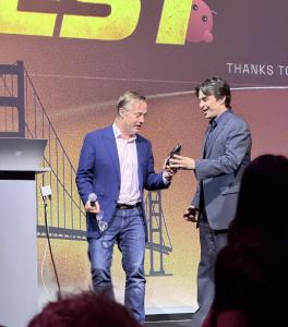 TopSend founder Nicholas Jarecki receives Best in Show award from Jason Calacanis on stage at LAUNCH Festival 2026 in San Francisco