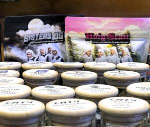 an image of the Sisters' brand of flowers in a glass case, with other vendors' products, in a dispensary in So Cal