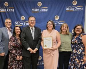 Erica Luna Gonzales holds an Assembly certificate alongside Assemblymember Mike Fong and Maryvale leadership team members in front of an Assemblymember Mike Fong District 49 backdrop