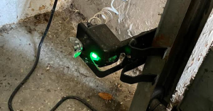 A wide, sunny shot of 20 brand new, fully equipped garage door service trucks parked in a neat row in Pasadena, California, featuring the company logo on the side panels.