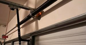 The brightly lit, organized interior of a garage door service van, showing neat racks of high-quality steel springs, automatic openers, cables, and replacement panels.
