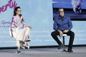 An image of the event FreedomFest in Las Vegas, pictures are media personality Kennedy, seated with Adam Carolla