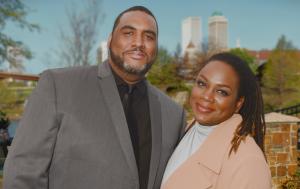 Love Mobile® co-founders Wade Dunn Jr. and Koddi Dunn standing together with the Tulsa, Oklahoma skyline in the background.