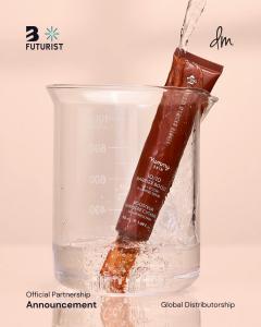  An overhead photograph of a brown Danessa Myricks Yummy Skin serum tube standing in a clear laboratory beaker filled with water.