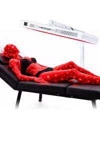 An artificial woman laying on a massage table receiving red light therapy.