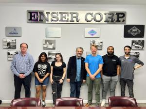 Group photo inside ENSER’s office beneath an ENSER Corp. sign. From left to right are ENSER Project Manager Mike Wahner, two female Temple University engineering students, Dr. Kurosh Darvish, Chair of Mechanical Engineering at Temple University, two male 