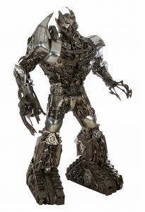 Large iron Megatron Transformer figure, impressive at 100 inches in height, designed and built by Kalifano using an assemblage of recycled auto parts. Estimate: $4,000-$8,000