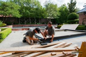 Brennan installation technicians on the ground assembling the frame for a large folding door.