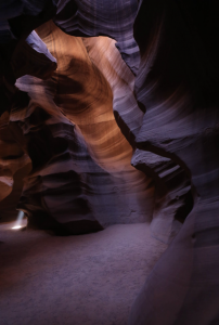 Curving sandstone formations inside Upper Antelope Canyon with soft light illuminating the narrow corridor.