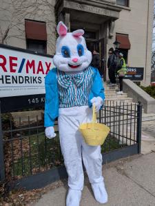 REMAX Hendriks Team Realty agent dressed as the Easter Bunny holding a basket at the St. Catharines Downtown Association Bunny Trail event.