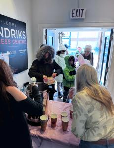 Community members and children visiting the REMAX Hendriks Team Realty office for refreshments during the St. Catharines Easter Bunny Trail.