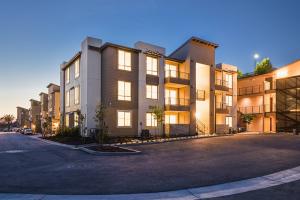 La Costa Family Apartments exterior at dusk in Carlsbad with illuminated balconies and contemporary multifamily design