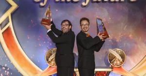 Photo of grand-prize winners writer Michael T. Kuester and illustrator Bafu with their award trophies