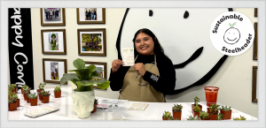 A participant receives a mini succulent plant after completing all stations at Exhibit Happy's Fix It Fair.