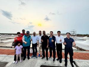 UN officials visiting traditional salt pans in Jingzaijiao, Taiwan, learning about historic salt production and sustainable cultural preservation.