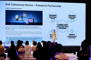 Aubry Lucien speaking on stage at 64K Cellssense event about systemic wellness