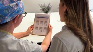 A clinician and patient review a VIOLET™ report, Future Fertility's egg quality report for egg freezing patients.
