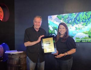 The owners of Platinum Copier Solutions proudly holding their HK Elite Award from Sharp for the year of 2025.