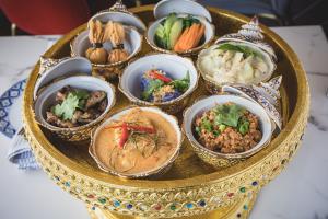 Khantok-style Thai platter at Kin Dee in Houston Heights featuring curry, noodles, and traditional Thai dishes.