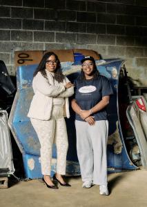 Natasha Broxton and her daughter inside an indoor automotive recycling warehouse in Milwaukee sorting and managing auto parts