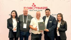 Members from Robotimize and Thor Assistive Technologies present at the partnership signing in front of Robotimize backdrop