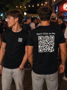 Man wearing a black Dont Click On Me QR code shirt in a city street, showing interactive apparel that encourages people to scan and connect  ? Why this works   Includes QR code shirt / interactive apparel (SEO keywords)   Describes the scene clearly   Hel