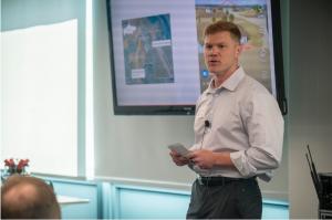 U.S. Marine Corps Maj. Christian Thiessen, a 2022 dual degree graduate from Naval Postgraduate School, delivers a pitch on his now-patented Detachable Drone Hijacker system during the school’s inaugural Reverse Pitch event, July 24, 2025.