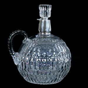 Bulbous demi-john jug, 12 ½ inches tall, exactly as featured in H.P. Sinclair, Jr. Glassmaker (Vol 1), with a full modified prism motif, pattern cut stopper, triple notched handle and ray cut base. Estimate: $750-$1,500