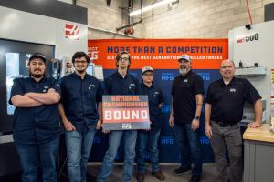 Six members of the Yuba College team pose in a machine shop in front of CNC equipment and a Project MFG backdrop, with one person holding a sign that reads “National Championship Bound,” indicating they are among four finalist teams.