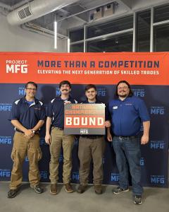 Four members of a college manufacturing team stand in front of a Project MFG backdrop, with one holding a “National Championship Bound” sign, indicating they are among the four finalist teams in the competition.