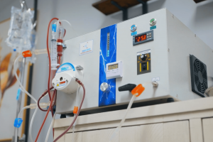 Close-up of EBOO therapy system showing tubing, filtration components, and control panel during treatment.