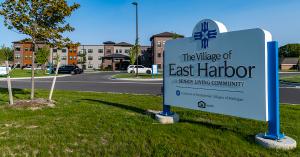 The Village of East Harbor front entrance and sign photo