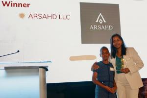Kerry Meikle holding the 2026 Corporate Champion for Babies award with her daughter Arianna Meikle at a Miami Diaper Bank event in Miami, Florida