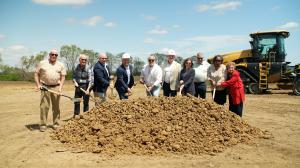 A group participates in the official groundbreaking ceremony for Millbrook, a new master planned community by Estridge Homes.