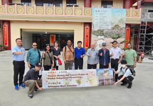 International delegation touring a temple in Nanhua, Taiwan, learning about plant-based diets, religious sustainability practices, and their role in carbon reduction and local circular economy.