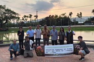 International delegation walking along a forest trail in Nanxi, Taiwan, observing firefly habitats and discussing ecotourism, biodiversity conservation and sustainable rural development.