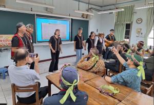 Siraya Indigenous people in Tainan teaching traditional songs to an international delegation, demonstrating cultural heritage sharing and Indigenous knowledge in a community gathering.