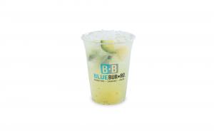 A Blue Burro branded cup filled with cucumber pineapple agua fresca over crushed ice.
