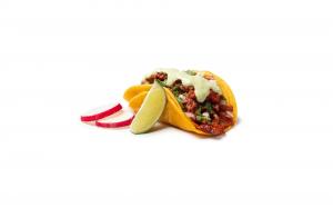 A corn tortilla taco filled with adobada, topped with cilantro and garnishes, served with lime.