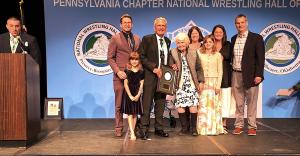 Paul Gilbert celebrates with family at National Wrestling Hall of Fame Pennsylvania Chapter ceremony after being named 2026 Outstanding American.
