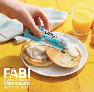 Daiya Cream Cheese Single-Serve being spread on a bagel.  Just one of many uses for this product across the menu.