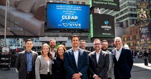 Teammates from ClearDrive Solutions and VIVE Collision standing in front of a billboard in Times Square