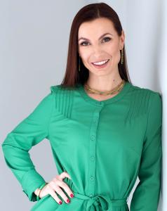 Professional portrait of psychotherapist Marinela Trickett smiling, wearing a green blouse, specializing in BPD, DBT & Emotional regulation and mental health care