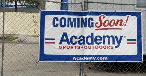 Academy Sports + Outdoors Coming Soon Sign hanging on fence at Fairview Town Center