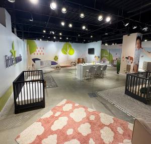 Dorel Juvenile showroom in High Point featuring branded wall graphics, dimensional lettering, and product display areas for Little Seeds and Maxi-Cosi.