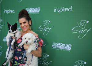 Lori Alan poses with her rescue dogs at the plant-based cooking show party featuring vegan recipes and vegan chefs