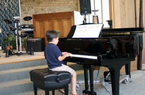 Young Piano Player Performing at Music Academy Recital