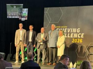 Scott Hoffman & Len Anhold from Fisher Barton accept John Deere Partner Award from Deere Team