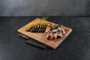 On one side of the board, you’ll find edge-grain Oregon Big Leaf Maple, a beautiful, durable hardwood long trusted in the kitchen. It offers a clean, modern look and a lighter weight that makes the board easy to handle and clean. The edge-grain construction provides a