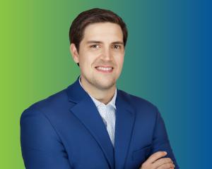 Headshot of Kevin Beall on a green-to-blue gradient background.